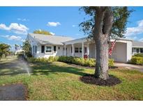 Charming single-story home with a well-maintained lawn, mature tree, and lovely landscaping at 4721 Mount Vernon Dr, Bradenton, FL 34210