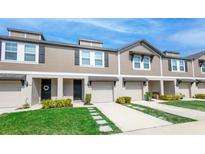 Charming townhome exterior features well-manicured lawns and individual driveways with attached garages at 17136 Blowfish Dr, Nokomis, FL 34275