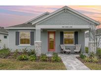 Charming single-story home featuring a cozy front porch and well-maintained landscaping at 1944 Vang Ln, Sarasota, FL 34240