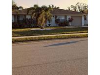 Charming one-story home featuring a well-maintained lawn and attached garage at 5876 Countrywood Dr, Sarasota, FL 34232