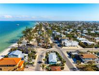 Aerial view of the turquoise beach house in a coastal community near the ocean at 912 N Shore Dr, Anna Maria, FL 34216