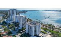 Aerial view of a luxury high-rise condominium with beautiful ocean views and mature landscaping at 435 S Gulfstream Ave # 804, Sarasota, FL 34236