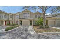 Charming townhome with well-maintained landscaping, garage, and inviting entrance with decorative door wreath at 7632 Plantation Cir, Bradenton, FL 34201