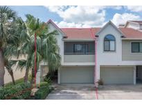 Inviting two-story townhome with attached garage and mature landscaping at 625 Duchess Blvd, Dunedin, FL 34698