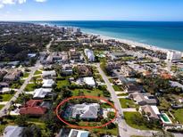 Aerial view of a home with a screened in pool near the ocean and beach at 721 Cadiz Rd, Venice, FL 34285