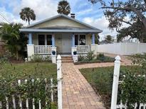 Charming bungalow with a brick walkway and a welcoming front porch at 1675 7Th St, Sarasota, FL 34236