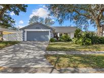Charming single-story home with an attached garage, lovely landscaping, and a well-maintained front yard at 5008 30Th Street E Ct, Bradenton, FL 34203