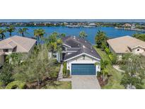 Waterfront property with tropical landscaping and view of marina at 5040 Lake Overlook Ave, Bradenton, FL 34208