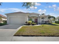 Charming single-story home features a two-car garage and a well-maintained front lawn, enhancing its curb appeal at 14205 Nighthawk Ter, Lakewood Ranch, FL 34202
