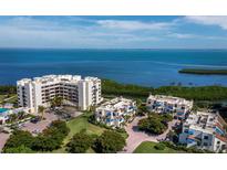 Stunning aerial view of waterfront condos with lush landscaping and tranquil bay views at 2012 Harbourside Dr # 2104, Longboat Key, FL 34228