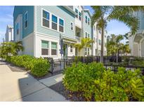 Beautiful townhome with a quaint patio featuring lush landscaping and an outdoor dining set at 2505 Boone Ct, Sarasota, FL 34237