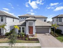 Beautiful two-story home featuring a well-manicured lawn and a two-car garage at 4793 Antrim Dr, Sarasota, FL 34240