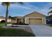 Charming single-story home features a well-manicured lawn, a two car garage and a welcoming front entrance at 7113 91St E St, Palmetto, FL 34221