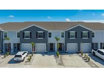 Charming townhomes featuring two-tone paint, well-manicured yards, and attached garages offer modern living at 8612 Milestone Dr, Sarasota, FL 34238