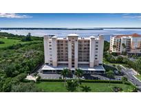 Stunning waterfront condo building with lush landscaping and covered parking at 2625 Terra Ceia Bay Blvd # 504, Palmetto, FL 34221