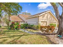 Inviting single story home with manicured lawn and colorful garden at 5727 Monte Rosso Rd, Sarasota, FL 34243