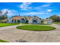 Spacious ranch style house with circular driveway and well maintained landscaping at 5750 Saddle Oak Trl, Sarasota, FL 34241