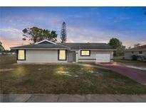 Charming single-story home featuring a well-maintained lawn and an attached one-car garage at 5798 Kenwood Dr, North Port, FL 34287