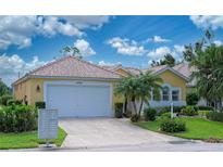 Charming single-story home featuring a well-manicured lawn and a two-car garage at 8503 Gateway Ct, Englewood, FL 34224
