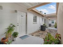 Charming entrance with white door, number 2907, stone pavers, and garden plants in view at 2907 51St W Ave, Bradenton, FL 34205