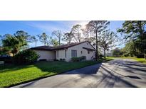 Inviting single-story home features mature trees, well-maintained lawn, and a tile roof at 3630 White Pine Ct # 138, Sarasota, FL 34238