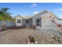 Charming home featuring a well-maintained yard, a mix of textures and neutral paint at 5002 Bunyan St, Sarasota, FL 34232