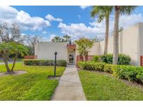 Charming single-story villa with a well-manicured lawn and walkway leading to the front door at 801 Spring Lakes Blvd # 801, Bradenton, FL 34210