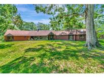 Sprawling single story house with large front yard, beautiful trees, and a tranquil setting at 805 Mcarthur Ave, Sarasota, FL 34243