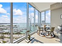 Bright breakfast nook with a round table and floor-to-ceiling windows overlooking the waterfront view at 1155 N Gulfstream Ave # 1709, Sarasota, FL 34236