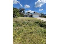Quaint single-story home with an attached two-car garage and arched entryway at 3722 S Cranberry Blvd, North Port, FL 34286
