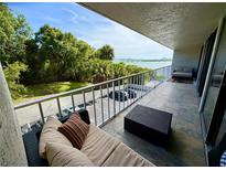 Spacious balcony with tile flooring, outdoor furniture, and a beautiful water view at 500 N Osceola Ave # 203, Clearwater, FL 33755
