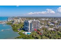 Stunning waterfront condo building featuring a pool and beautiful landscaping, located on serene waters at 500 N Osceola Ave # 203, Clearwater, FL 33755