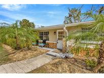 Inviting front entrance with stone accents, tiled walkway, and tropical landscaping for a warm, welcoming curb appeal at 7262 Alafia Ridge Loop, Riverview, FL 33569