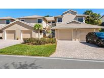 Inviting townhome with a two-car garage and beautiful brick paved driveways at 1718 Starling Dr # 104, Sarasota, FL 34231