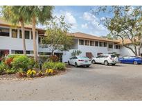 Condominium exterior showing well-manicured tropical landscaping, neutral paint and convenient parking at 3330 Thornwood Rd # 3330, Sarasota, FL 34231