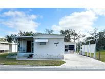 Charming single-story home with a well-maintained front yard and long driveway at 415 Oakwood E Blvd, Sarasota, FL 34237