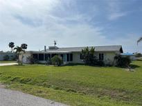 Inviting single-story home with lush green lawn and mature landscaping, offering a serene living environment at 4764 Argonaut Rd, Venice, FL 34293