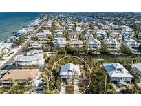 Gorgeous elevated aerial shot showcases this Florida home's location close to the ocean and other homes at 527 Magnolia Ave, Anna Maria, FL 34216
