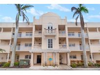 Exterior building view featuring well-maintained landscaping, beautiful balconies, and detailed architecture at 5970 Midnight Pass Rd # 177, Sarasota, FL 34242