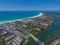 Sweeping aerial view of beachfront community with sparkling ocean and Intracoastal waterway at 6415 Midnight Pass Rd # 910, Sarasota, FL 34242