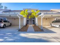 Condo with covered parking, landscaped walkway, and access stairs to the upper units at 801 Montrose Dr # 202, Venice, FL 34293