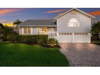 Charming two-story home with grey siding, metal roof, and a welcoming yellow front door at 1528 43Rd Avenue W Dr, Palmetto, FL 34221