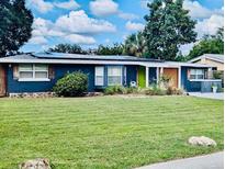 Charming single-story home with well-maintained lawn and vibrant landscaping at 2109 Lee Ln, Sarasota, FL 34231