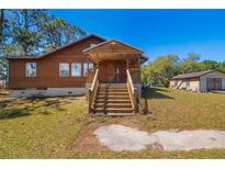 Inviting two-story home featuring wood facade, covered porch and ample space at 34200 State Road 62, Parrish, FL 34219