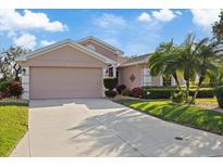 Charming single-story home with a two car garage, mature landscaping, and inviting curb appeal at 5141 Lansdowne Way, Palmetto, FL 34221