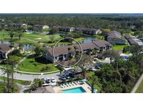 Aerial view of condo community with pool, golf course, and lakes at 5320 Hyland Hills Ave # 2222, Sarasota, FL 34241