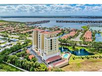 Luxury condo building boasts waterfront views, a pool, lush landscaping, and convenient parking for upscale living at 501 Haben Blvd # 204, Palmetto, FL 34221