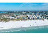 Discover resort-style living with beach access, a pool, and a lake in a beautiful condo community from an aerial view at 5780 Midnight Pass Rd # 210, Sarasota, FL 34242
