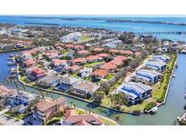 Beautiful waterfront community with red tile roofs and boat docks on canals leading to the open bay at 12622 Safe Harbour Dr, Cortez, FL 34215