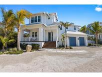 Stunning two-story home boasting lush landscaping, covered porch and two-car garage at 211 81St St # B, Holmes Beach, FL 34217
